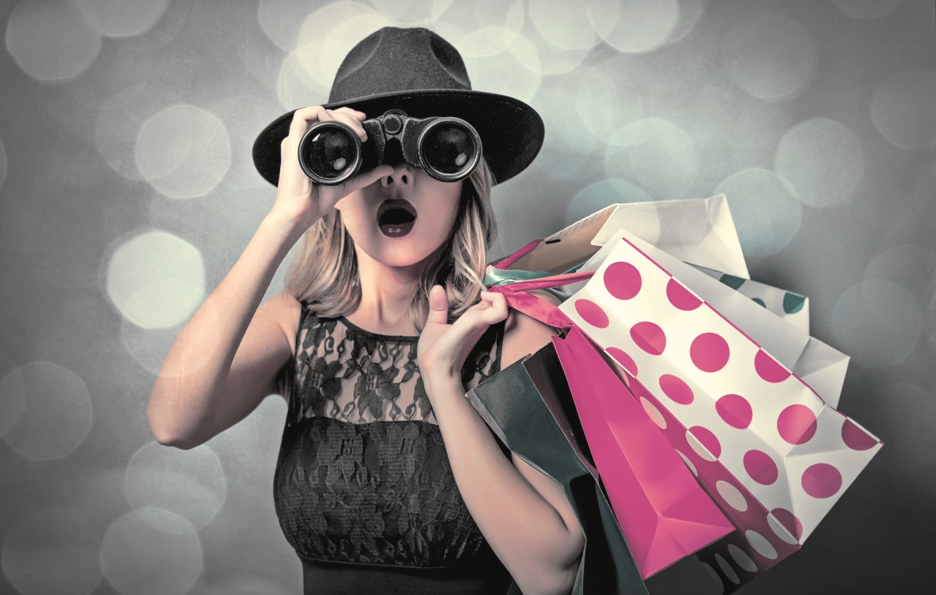 Woman in dress with binoculars looking for shopping to buy